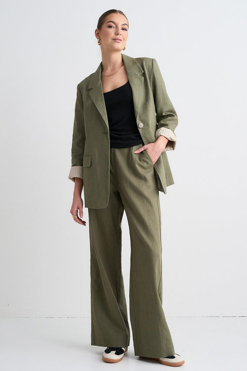 model wears green linen pants