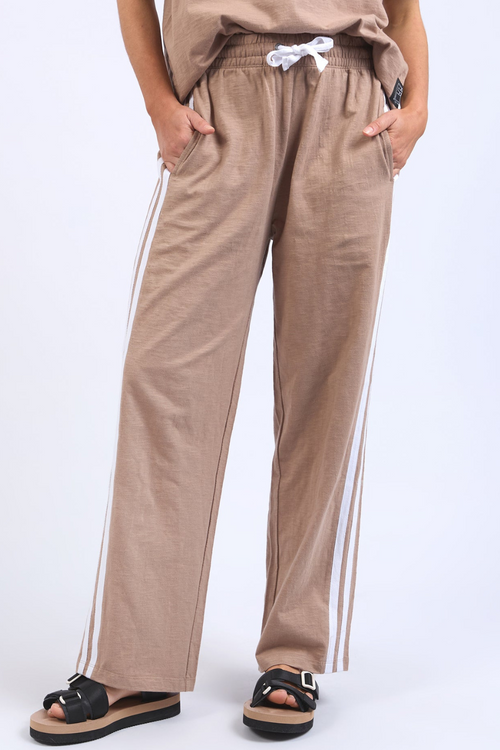 model wears casual brown pants and top set