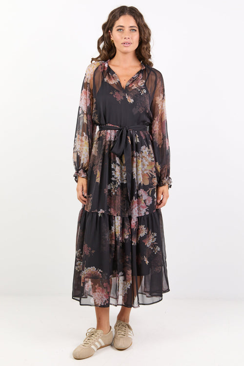 Black dress with floral print, balloon sleeves and tiered skirt.