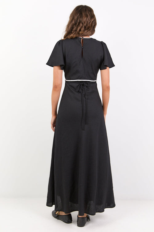 Woman wearing a black dress with a white background
