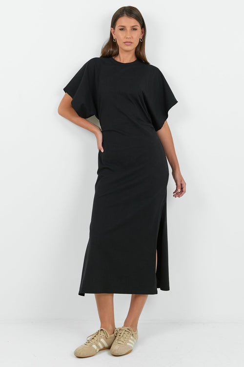 Woman wearing a black dress with a white background
