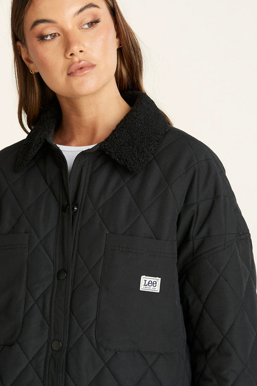 model wears a Black Quilted Jacket