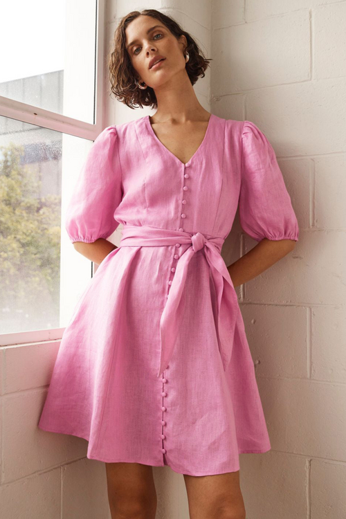 model wears pink linen mini dress