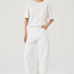 Woman wearing white wide leg jeans 