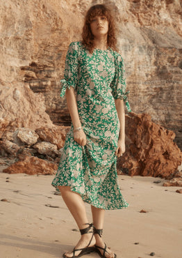 Model wears a green floral Maxi Dress