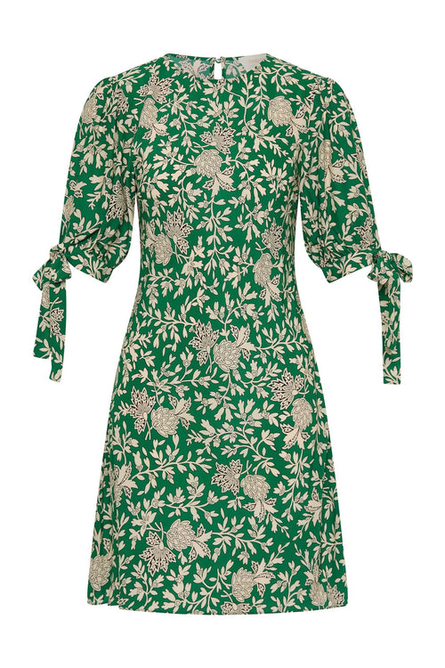 Model wears green floral mini dress