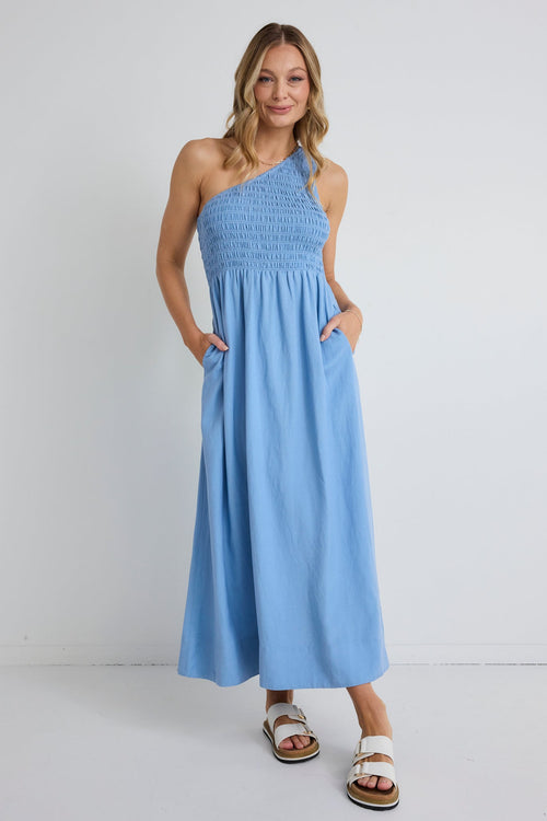 Woman wearing a light blue dress with a white background