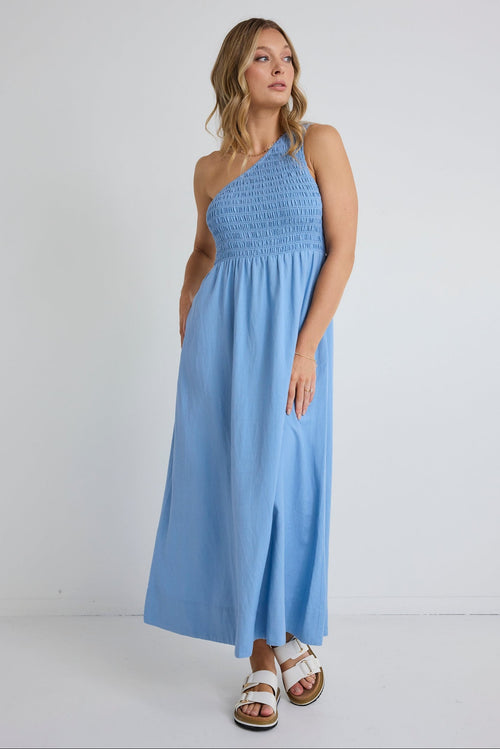 Woman wearing a light blue dress against a white background