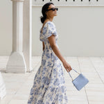 model wears a blue floral maxi dress