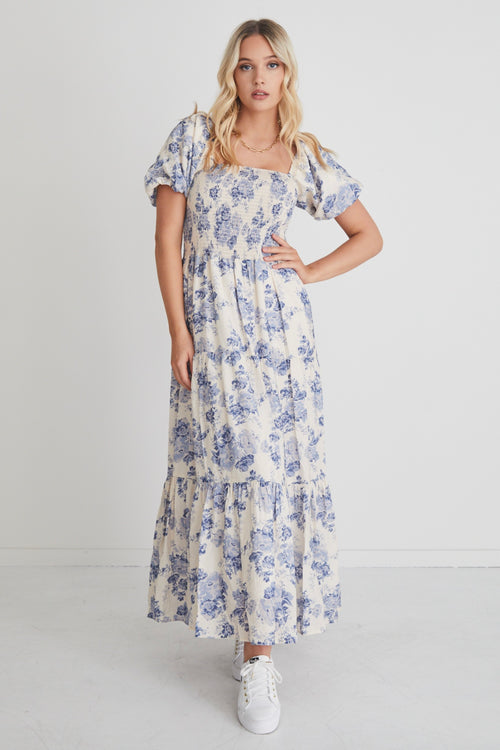 model wears a blue floral maxi dress