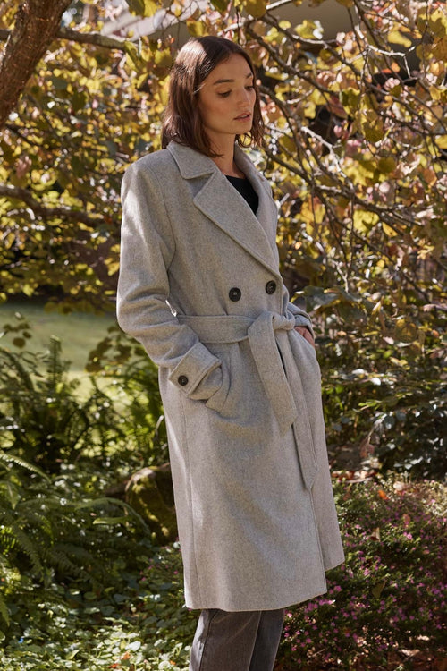 model wears a grey coat