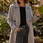 model wears a grey coat