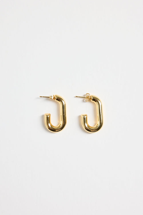 gold-plated brass huggie earrings with a sleek rectangular shape, photographed flat on a white background.
