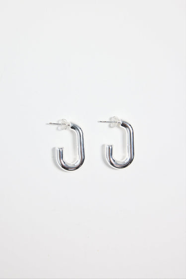 silver-plated brass huggie earrings with a rectangular shape, photographed flat on a white background.