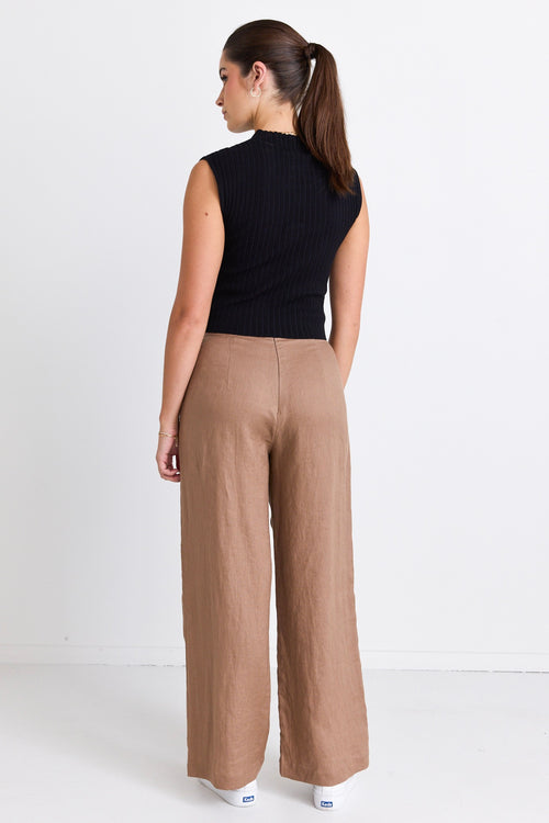 model wears brown linen pants