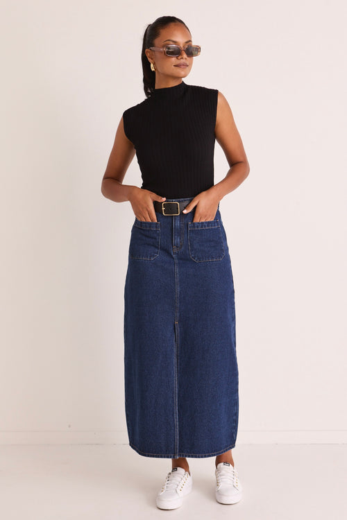 model wears a blue denim maxi skirt