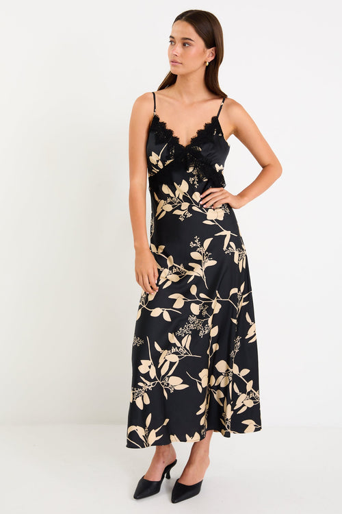 Woman wearing a black floral dress on a white background