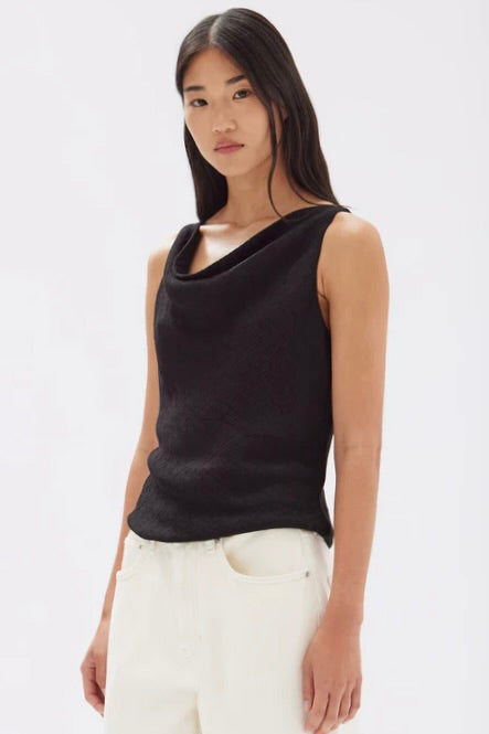 model wears a black cowl neck top