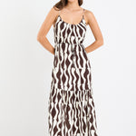A strappy, tiered dress with a bold chocolate and cream geometric print. Made from 100% viscose for a light, breathable feel.