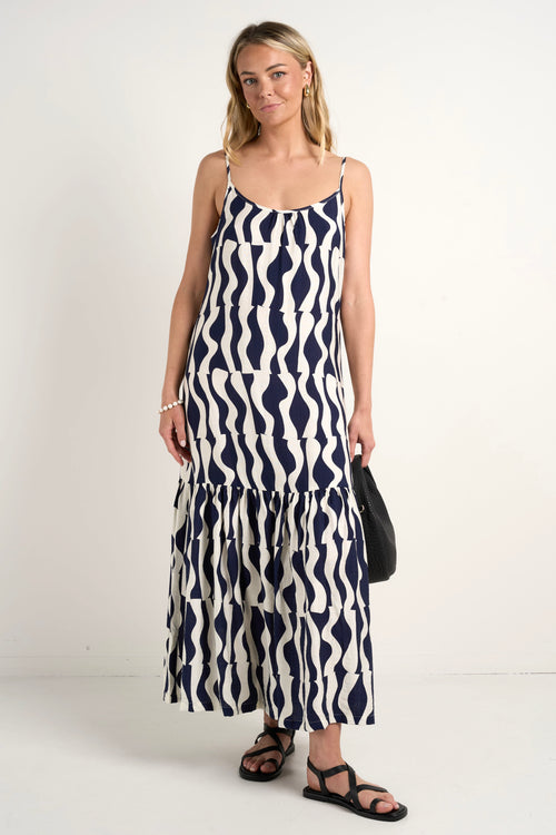 model wears a black and navy stripe maxi dress