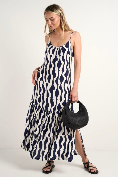 model wears a black and navy stripe maxi dress