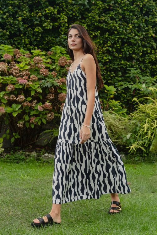 model wears a black and navy stripe maxi dress