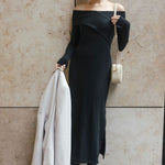 model wears a black off the shoulder maxi dress