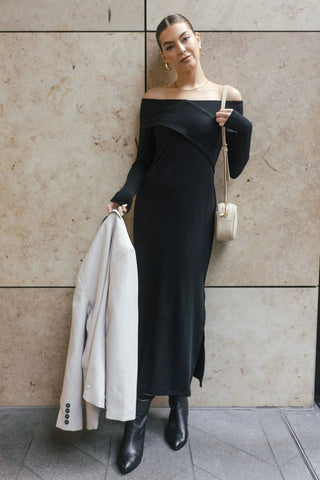 model wears a black off the shoulder maxi dress