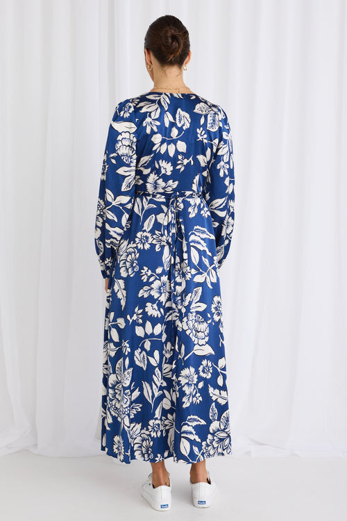 model wears a blue floral maxi dress