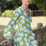 model wears a long sleeve green floral maxi dress