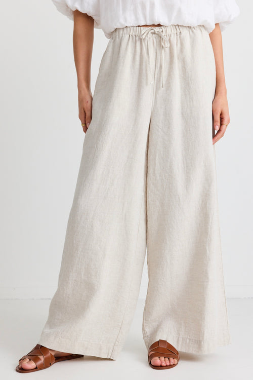 model wears a beige wide leg linen pant