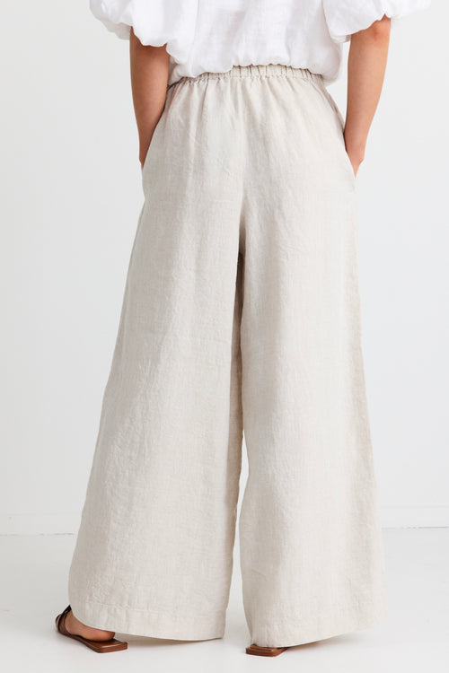 model wears a beige wide leg linen pant