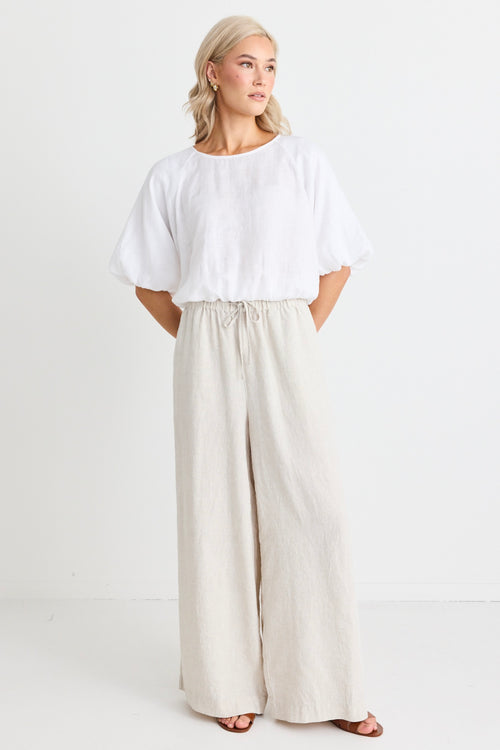 model wears a beige wide leg linen pant