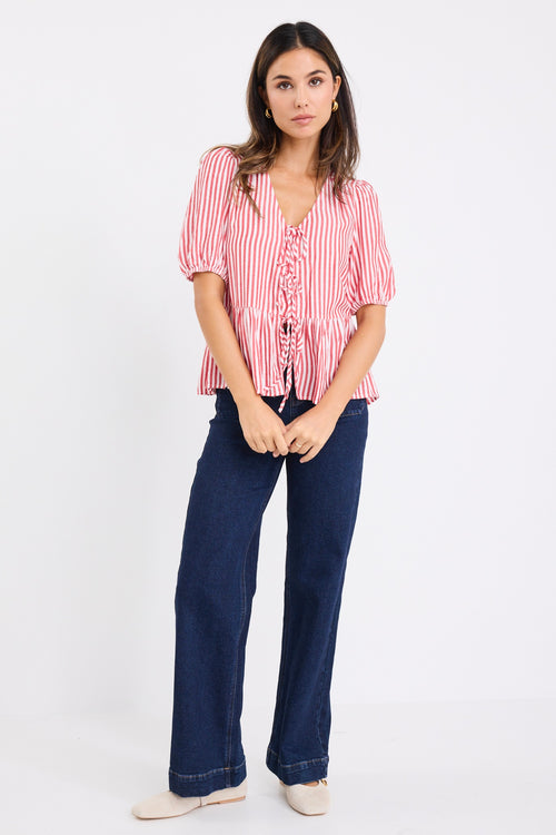 Model wears a red and white stripe short sleeve top with dark blue jeans