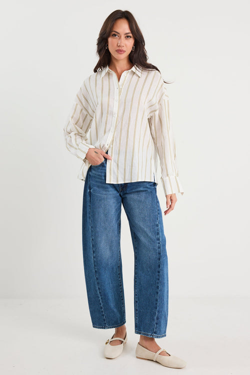 Woman wearing a striped shirt and blue jeans on a white background