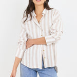 Woman wearing a striped shirt and jeans on a white background