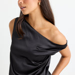 model wears a black satin one shoulder top