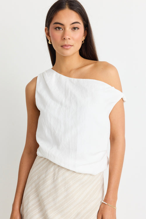 model wears a white linen one shoulder top