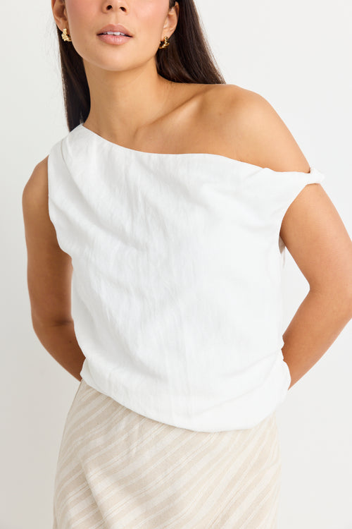 model wears a white linen one shoulder top