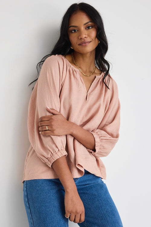 model wears a pink linen top 