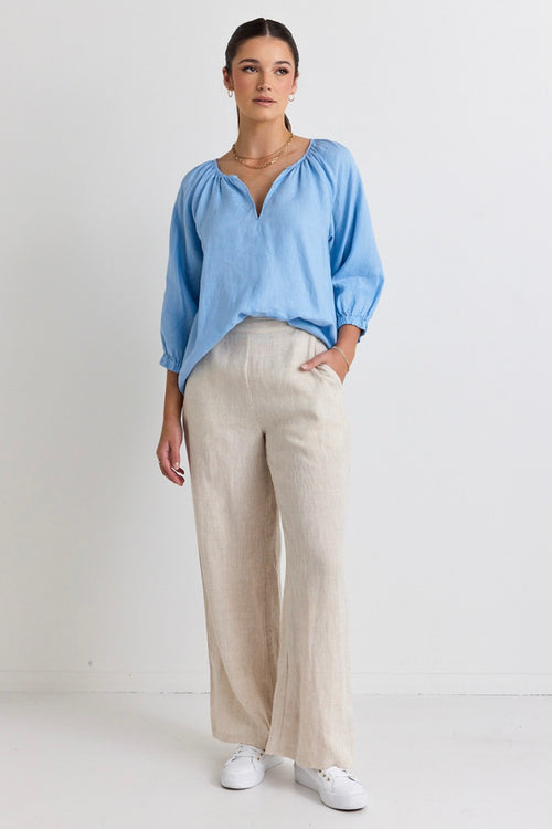 model wears a blue linen blouse