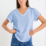 model wearing a blue v neck tee and jeans