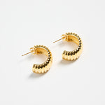 gold-plated brass huggie earrings with a ridged design, photographed flat on a white background.