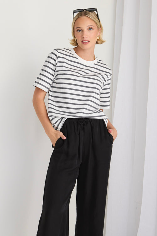 model wears a black and white stripe tee