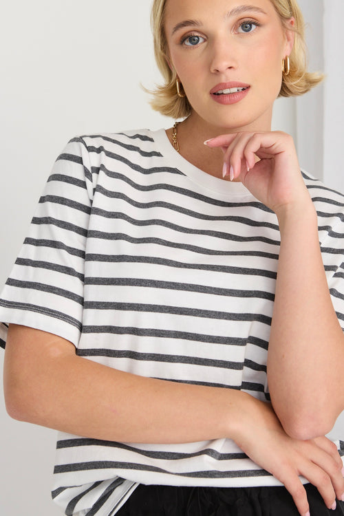 model wears a black and white stripe tee