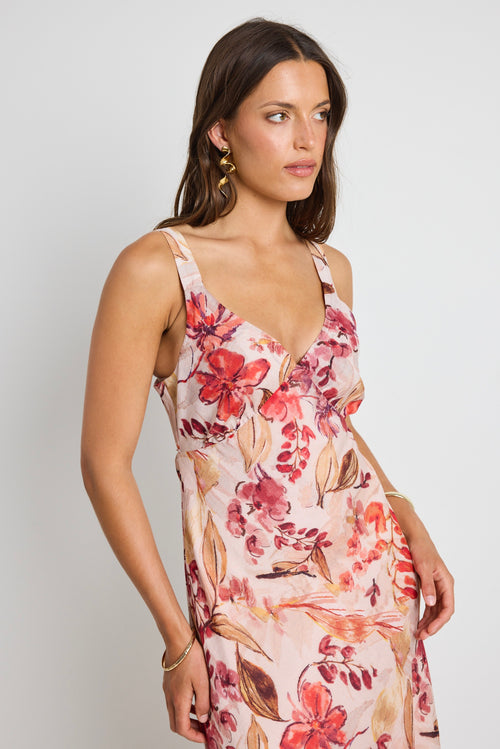 Model wears a strappy floral blush maxi dress