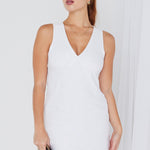 model wears a white linen mini dress