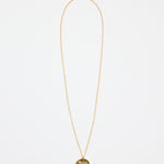 gold-plated necklace with fine chain and a round sunburst pendant featuring a central gem detail,