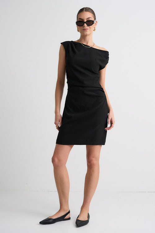 Model wears a one shoulder black mini dress
