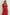 Woman wearing a red floral dress against a plain background